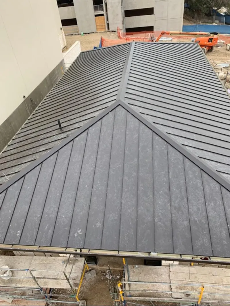 Commercial metal roof construction with crane equipment in Allegheny